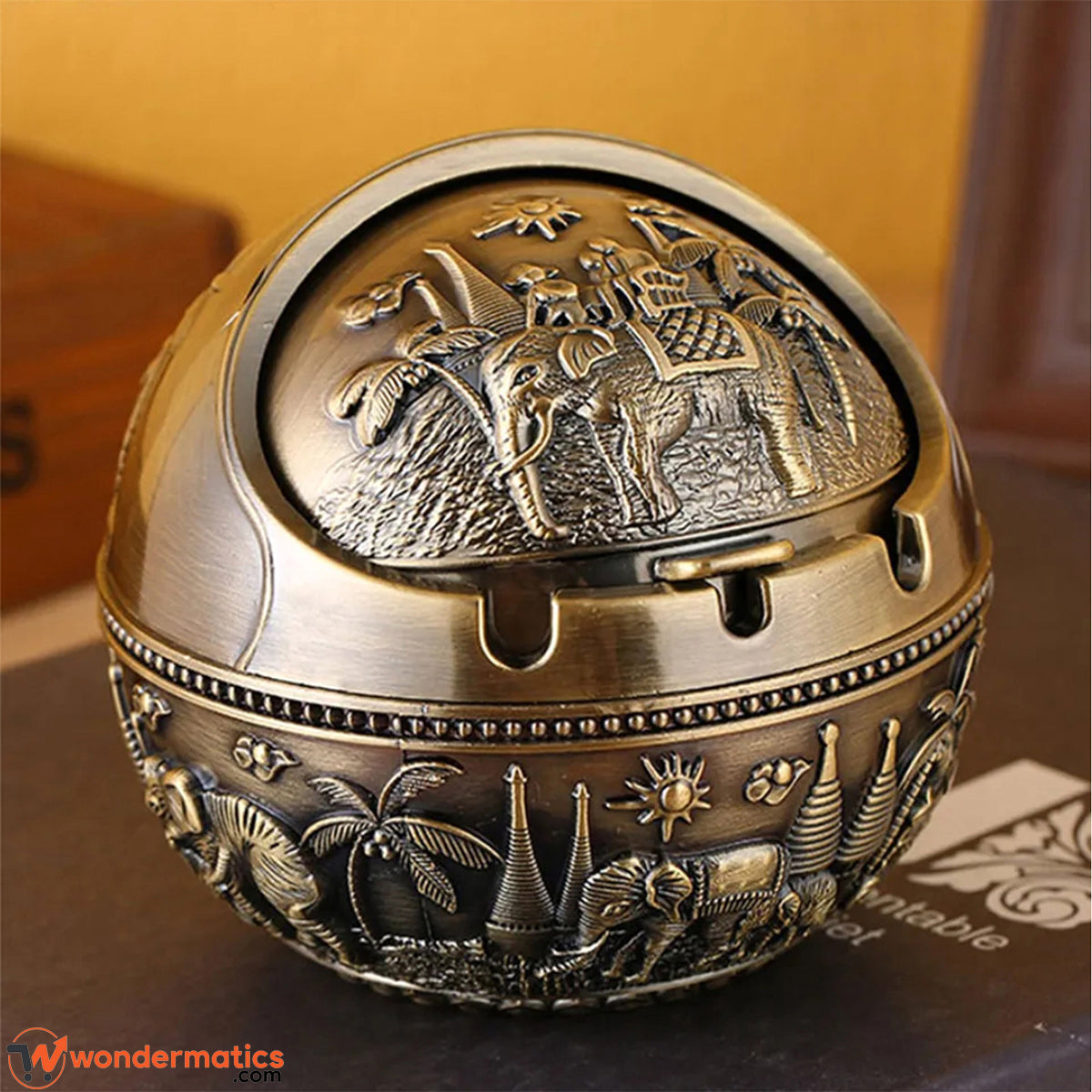 Vintage brass ashtray with lid placed on a wooden drawing room table in a Pakistani home setting