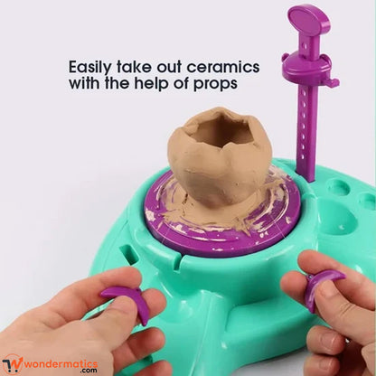 Child's clay pitcher shaped on the motorized pottery wheel with purple support arm