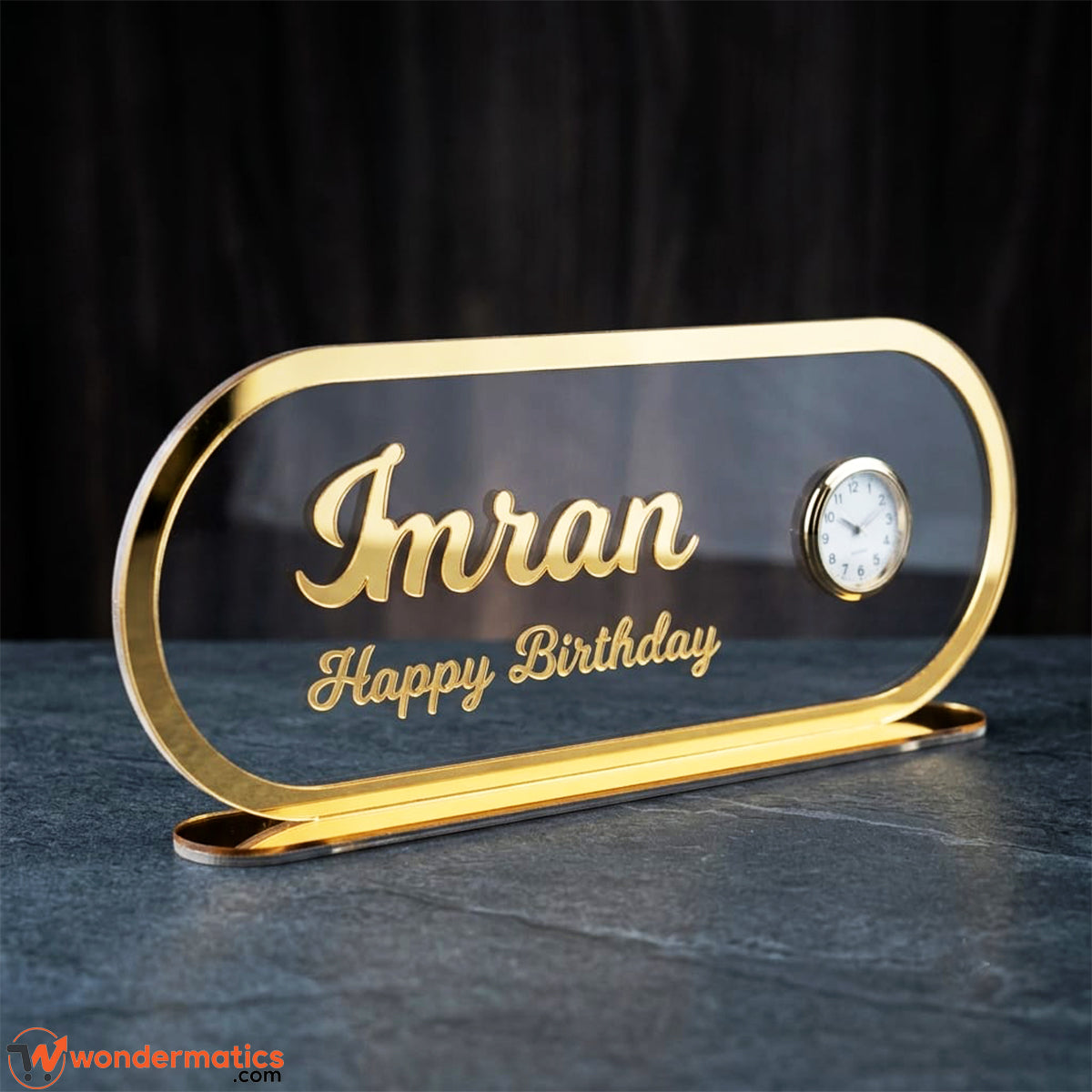 Close-up of golden name engraving detail on acrylic surface