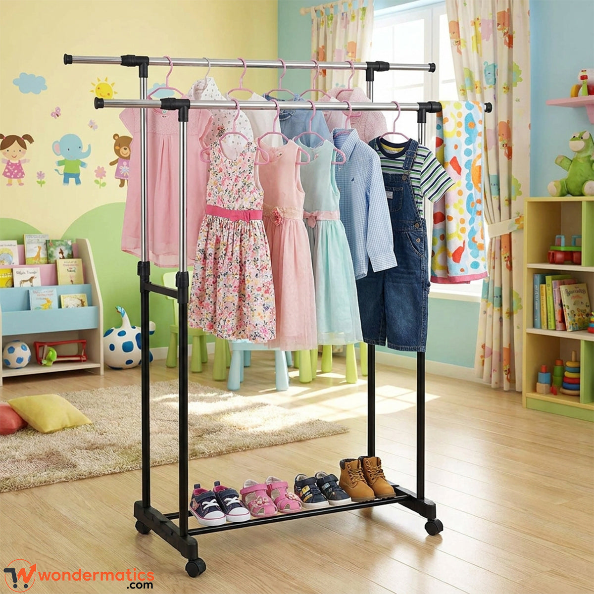A black metal two-bar clothing rack with a lower shoe shelf, shown in a colorful children's bedroom. Several children's dresses and shirts are hanging on the rack, along with a pair of jeans.