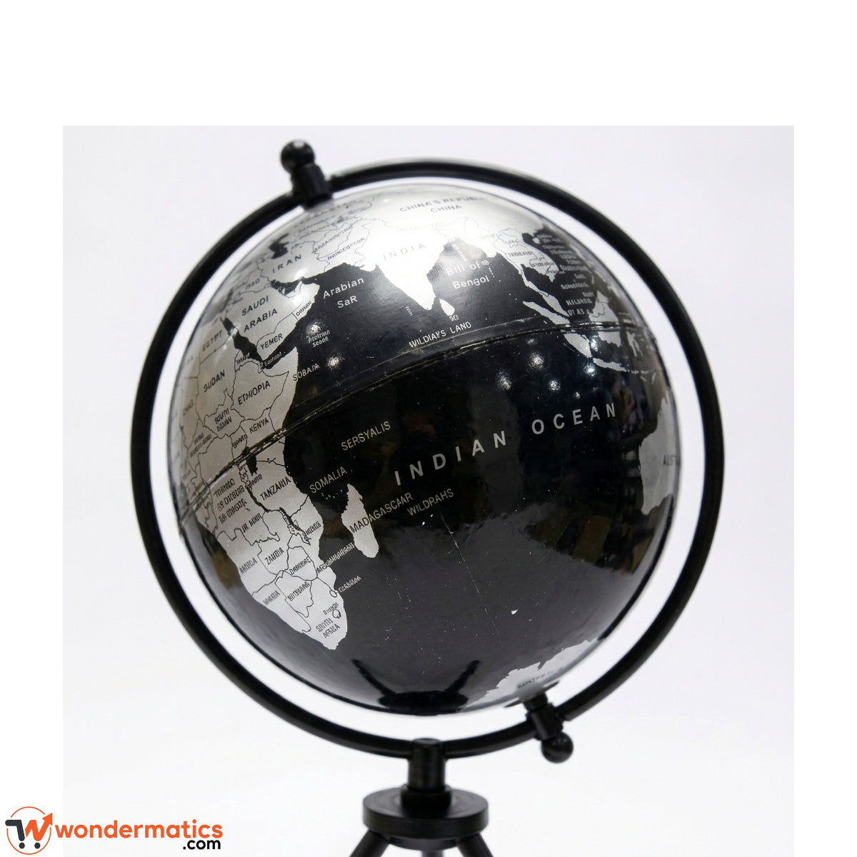 Close-up of black and silver map detailing on rotating globe