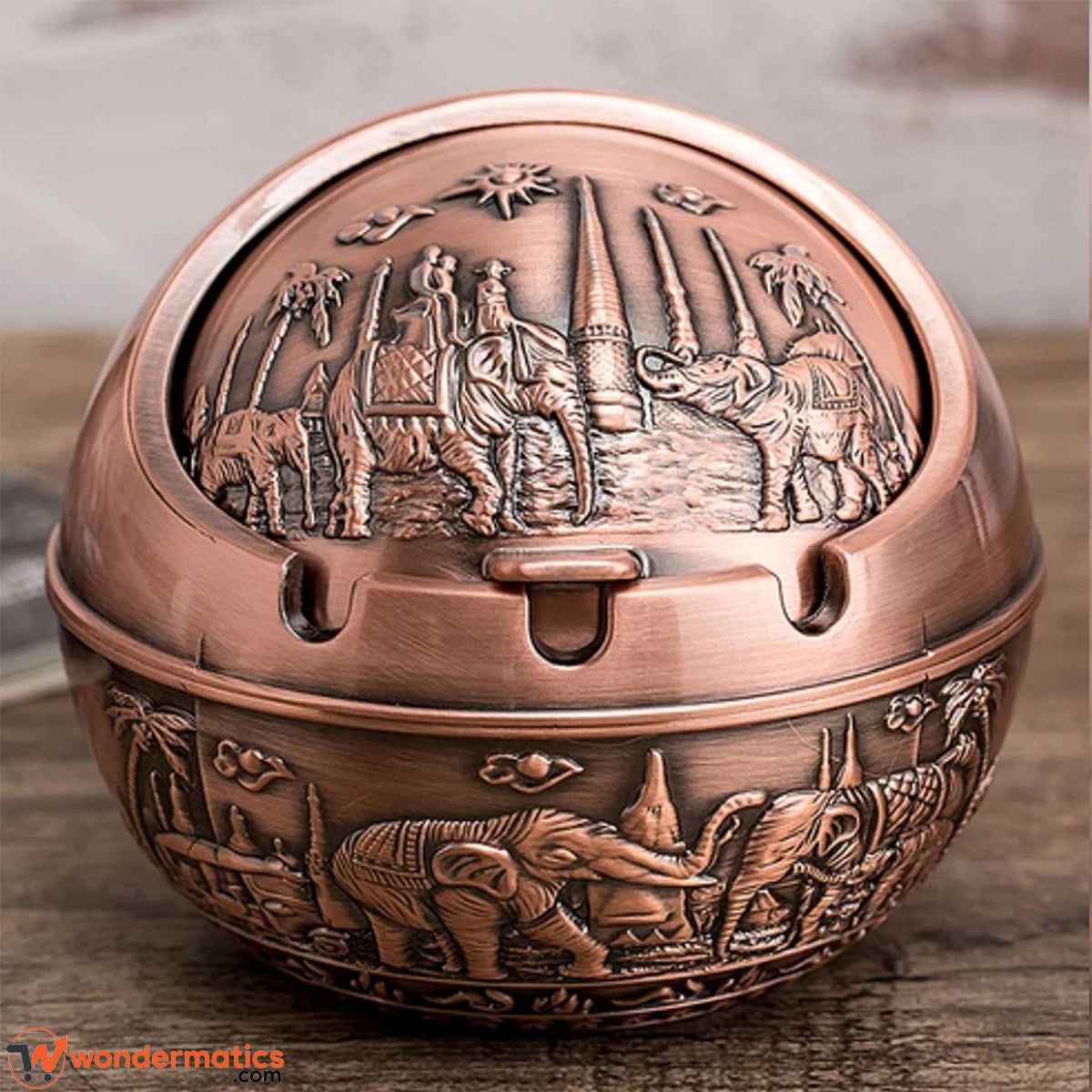 Close-up of brass ashtray hinged lid showing solid metal build and vintage golden finish