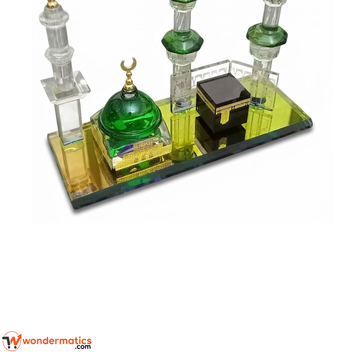 Close-up of crystal glass Kaaba showpiece reflecting light on mirror tray