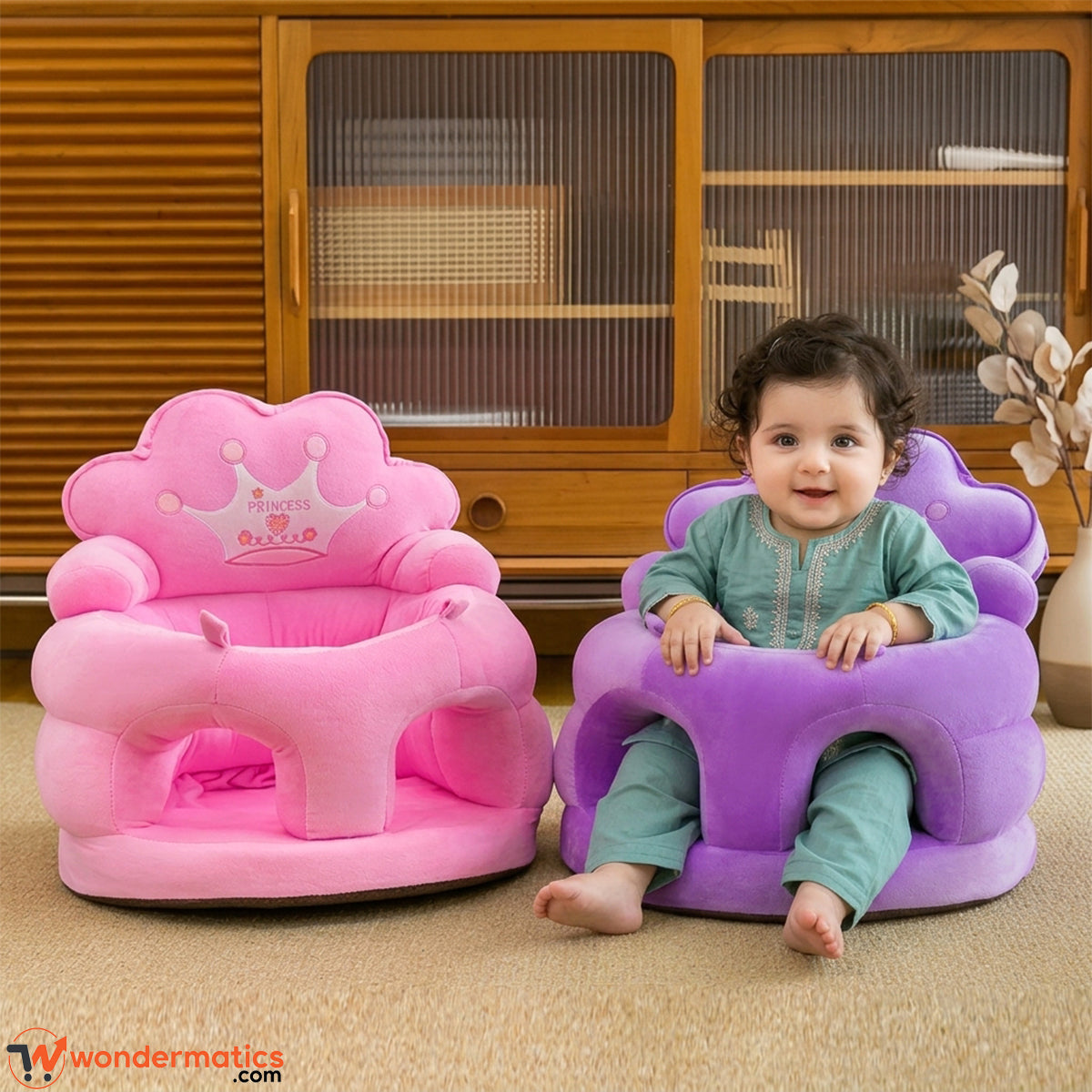 Baby sitting supported in plush crown floor seat at home