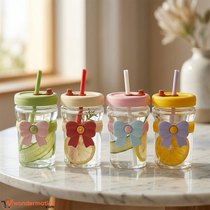 Young woman sipping iced coffee through straw in aesthetic bow-knot pastel glass cup in bright home setup