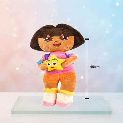 A Dora the Explorer plush toy standing on a clear display base, holding a yellow star, with a vertical height marker indicating 40cm. The background is a soft pastel gradient with light bokeh.