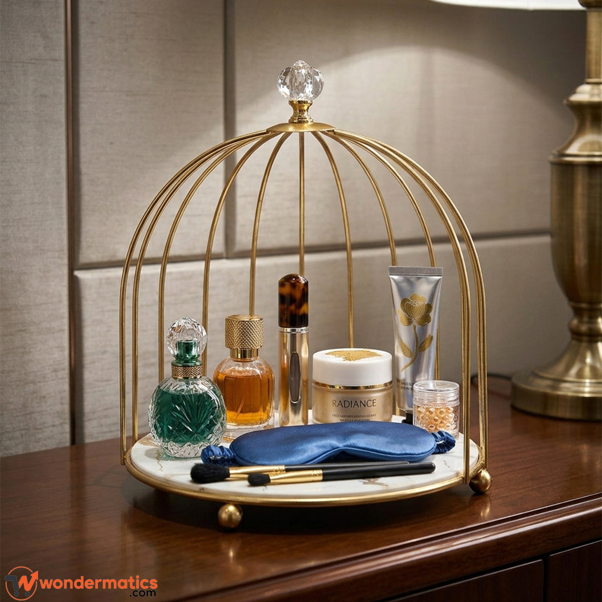 Gold cage vanity organizer holding perfumes, lipsticks and jewelry on a dressing table