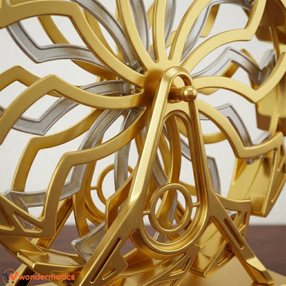Close-up of the geometric detailing and gold finish on a Ferris wheel sculpture