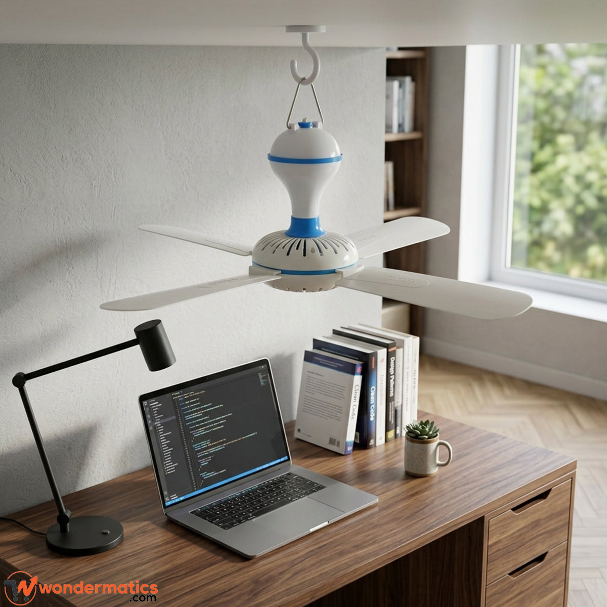 Portable mini fan hanging near a study table for students