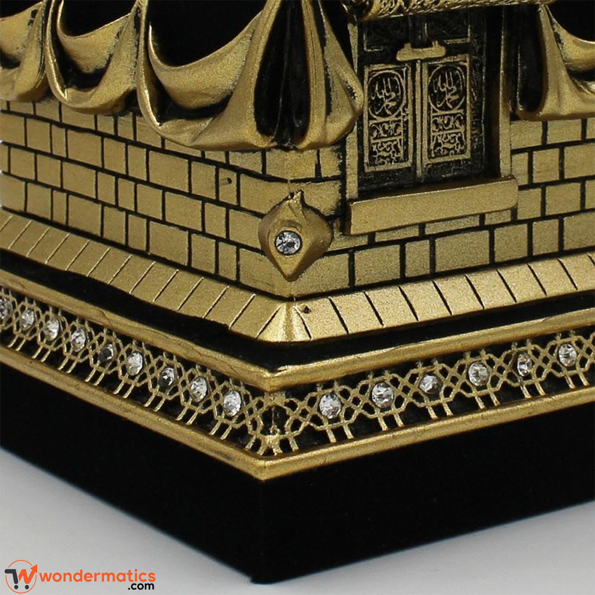 Close-up of ornate Arabic calligraphy detailing on Kaaba showpiece