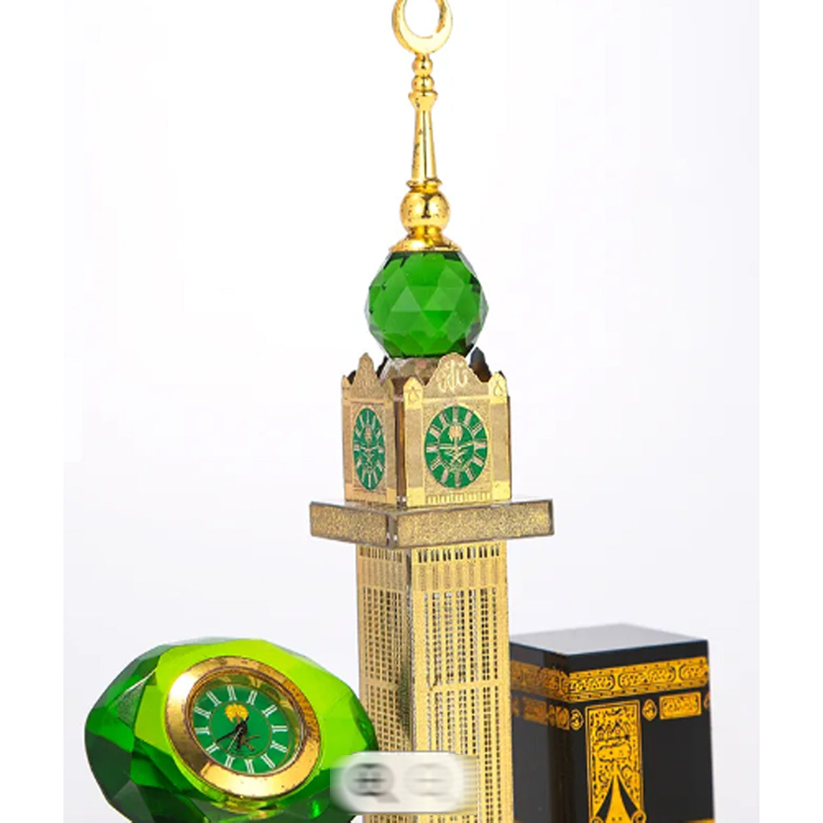 Side angle of crystal Kaaba clock showing Makkah Tower and table clock