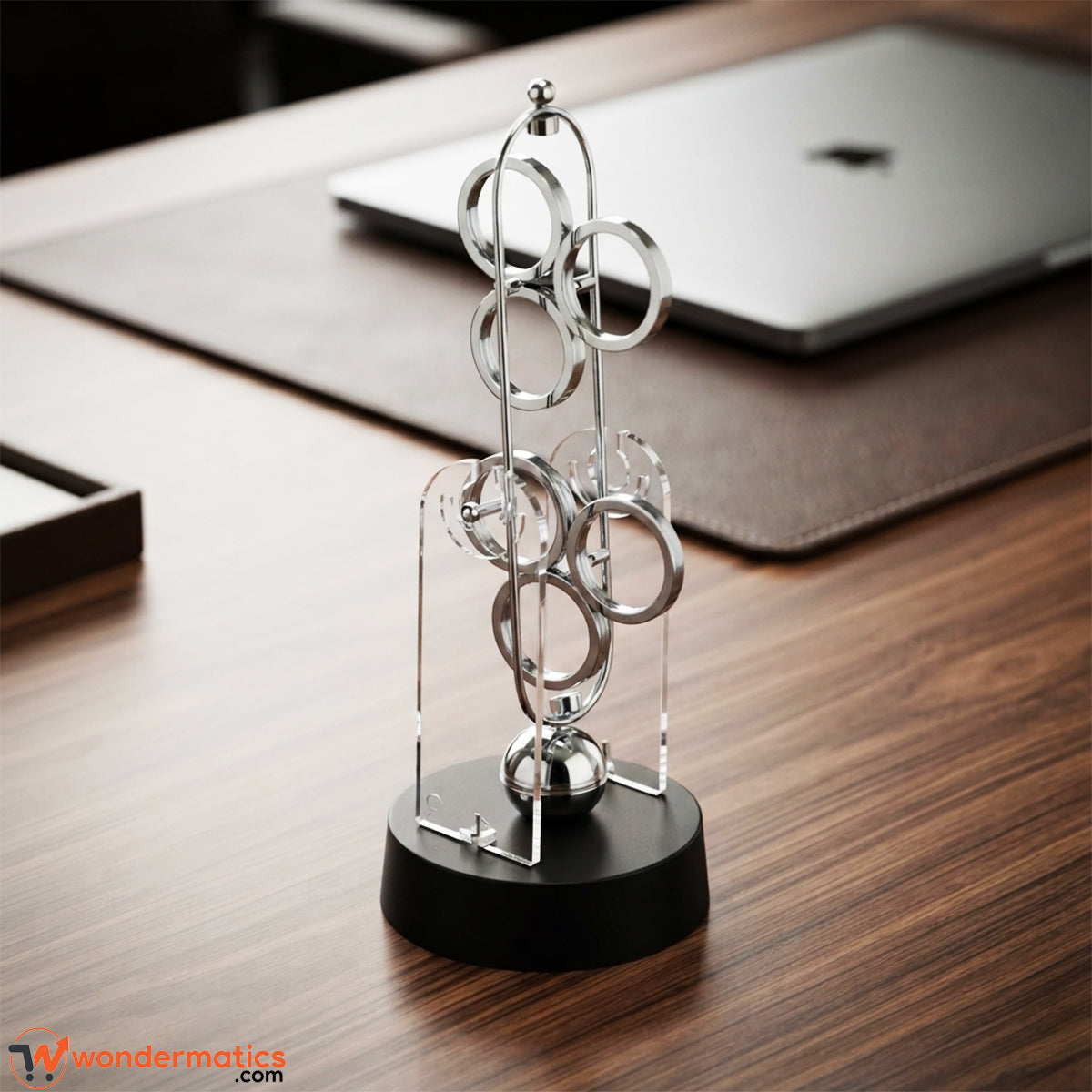 Front view of a kinetic desk decoration piece with plastic base and plastic rings