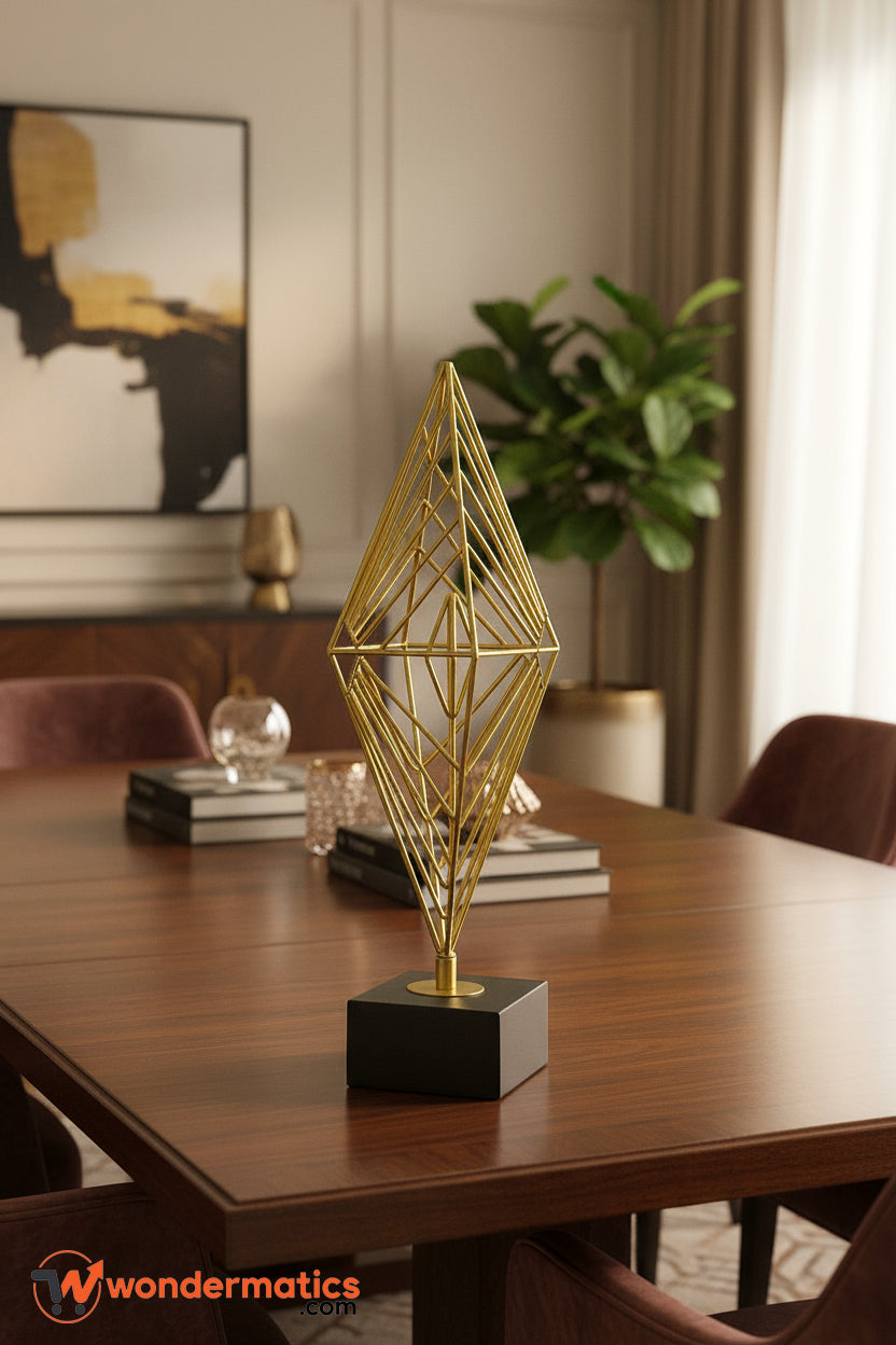 Modern geometric diamond-shaped gold sculpture on black base – tabletop ornament