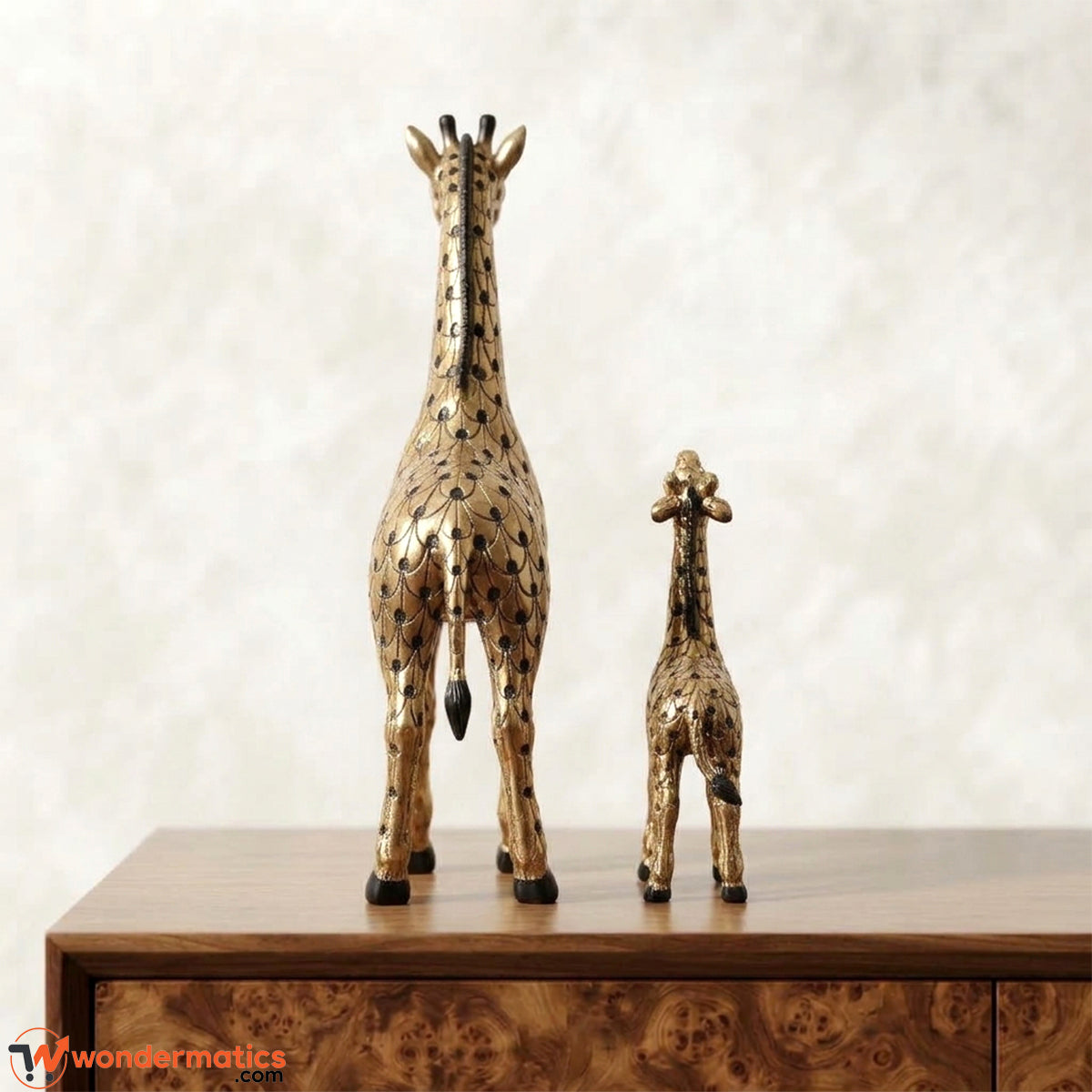 Back view of gold mother giraffe and calf figurines with black scale etching