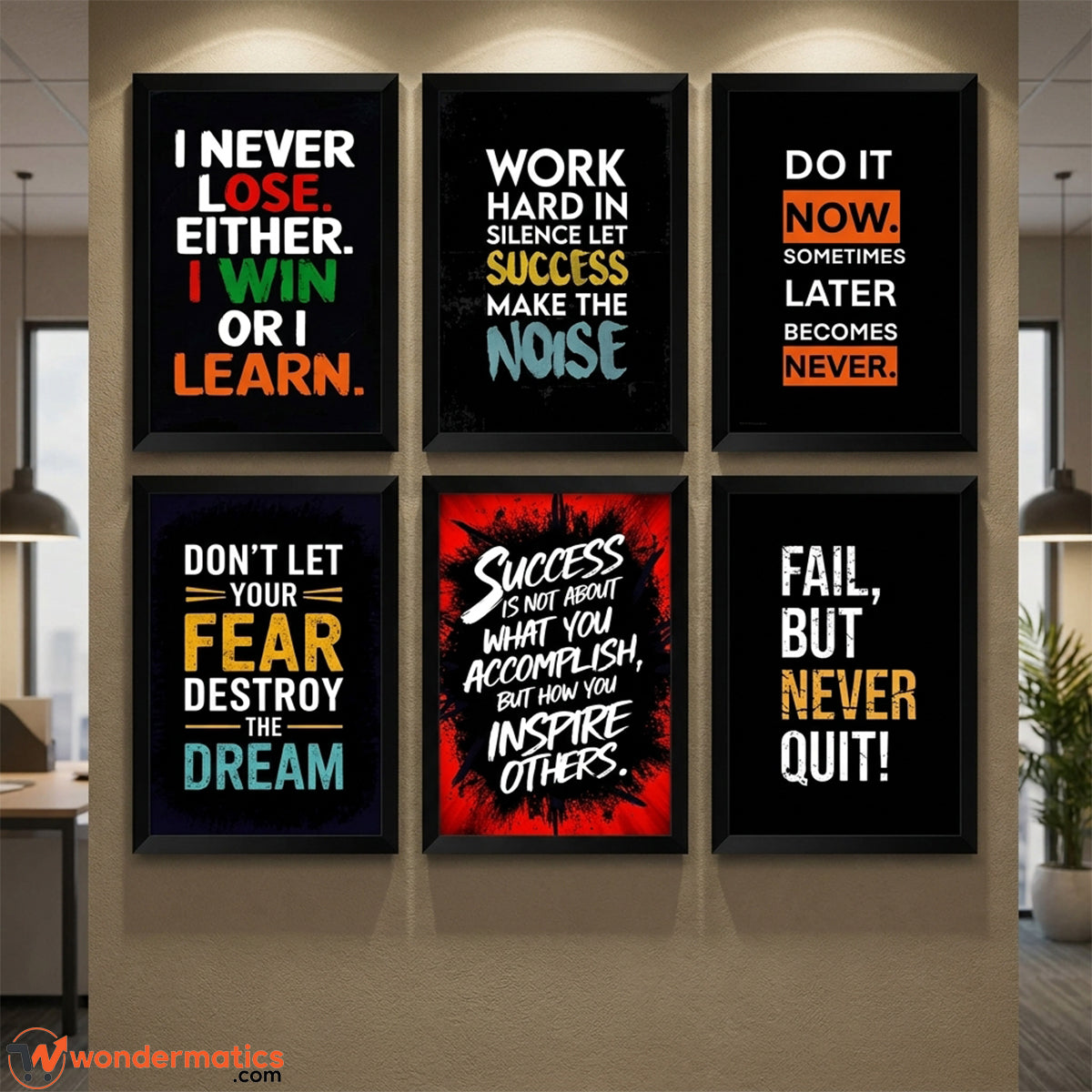 Six framed motivational wall art prints arranged in a 2x3 grid on a beige wall in an office-like interior. The prints feature black backgrounds with colorful text quotes including 'I Never Lose.