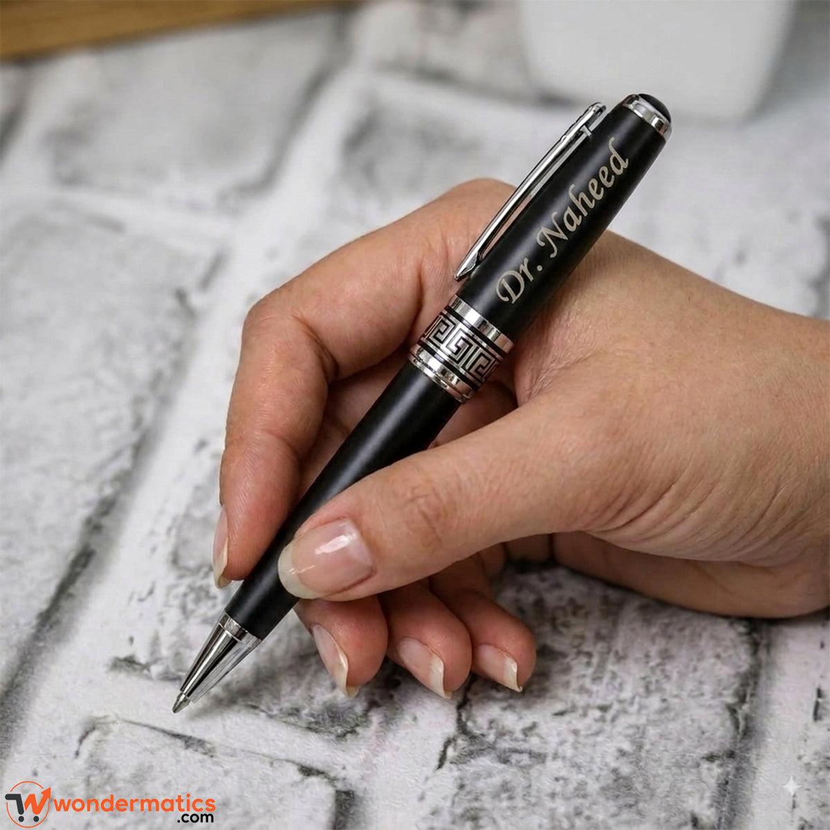 Custom engraved pen held in hand showing writing size and grip