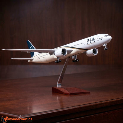A scale model of a Pakistan International Airlines (PIA) passenger jet displayed on a wooden stand on a polished wooden table, with a dark wood background.