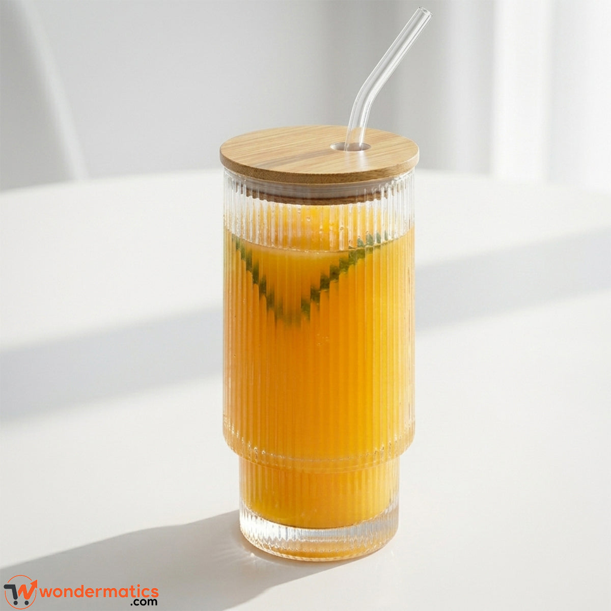 Ribbed glass tumbler 450ml with bamboo lid and glass straw on white background by Wondermatics