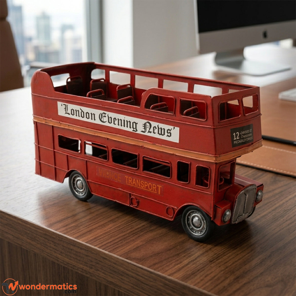 Vintage red London double-decker bus model styled as decor on an office desk setup