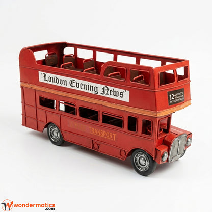 Side profile of vintage red tinplate double-decker bus model showing full length and window detailing
