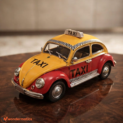 A vintage-style metal car model shaped like a Volkswagen Beetle, painted in a classic yellow and red taxi livery with black checkered stripes and 'TAXI' lettering, displayed on a reflective wooden surface for home and office decor