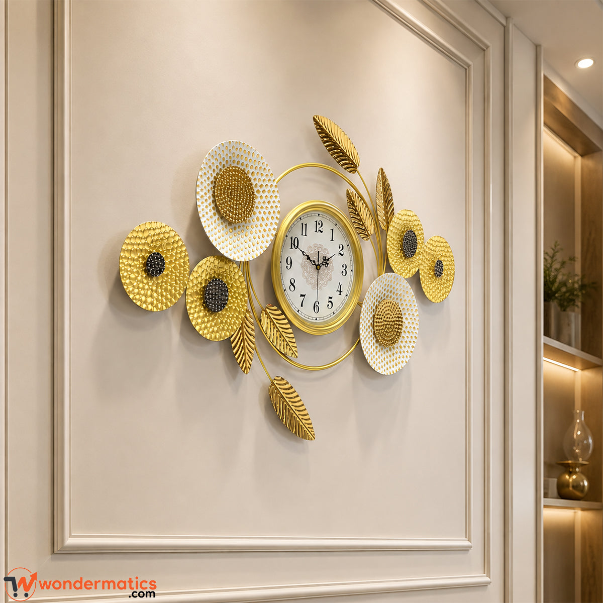 Detail of sculpted gold metal leaf accents on decorative wall clock
