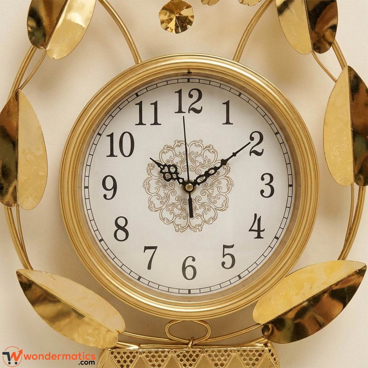 Close-up of white analog clock dial with gold frame on floral wall art
