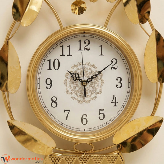 Close-up of white analog clock dial with gold frame on floral wall art