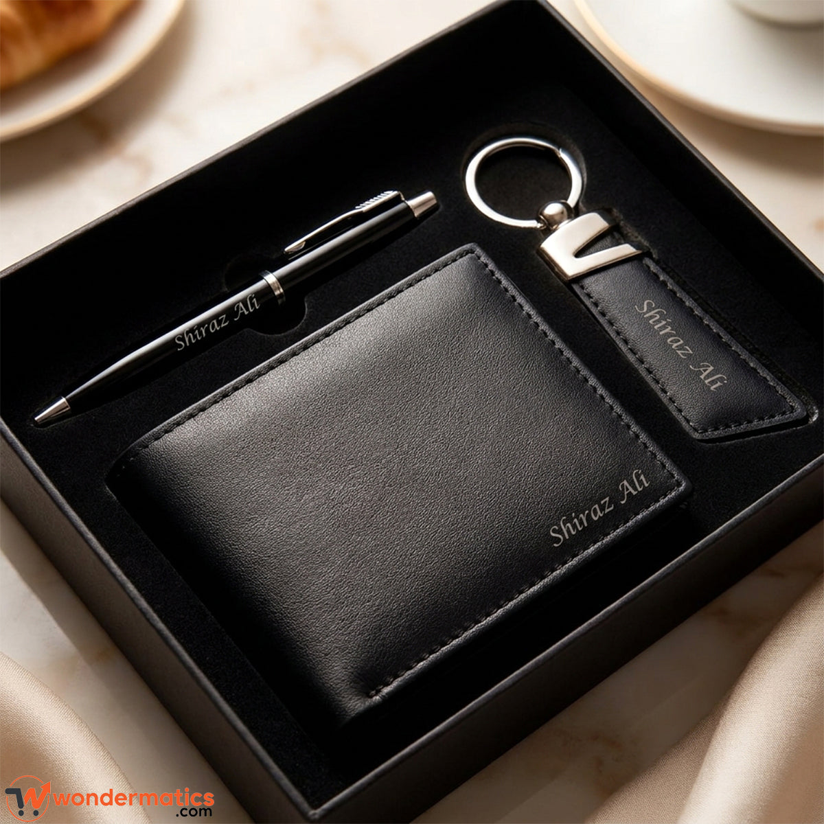 Personalized black genuine leather wallet, keyring and pen gift set on display