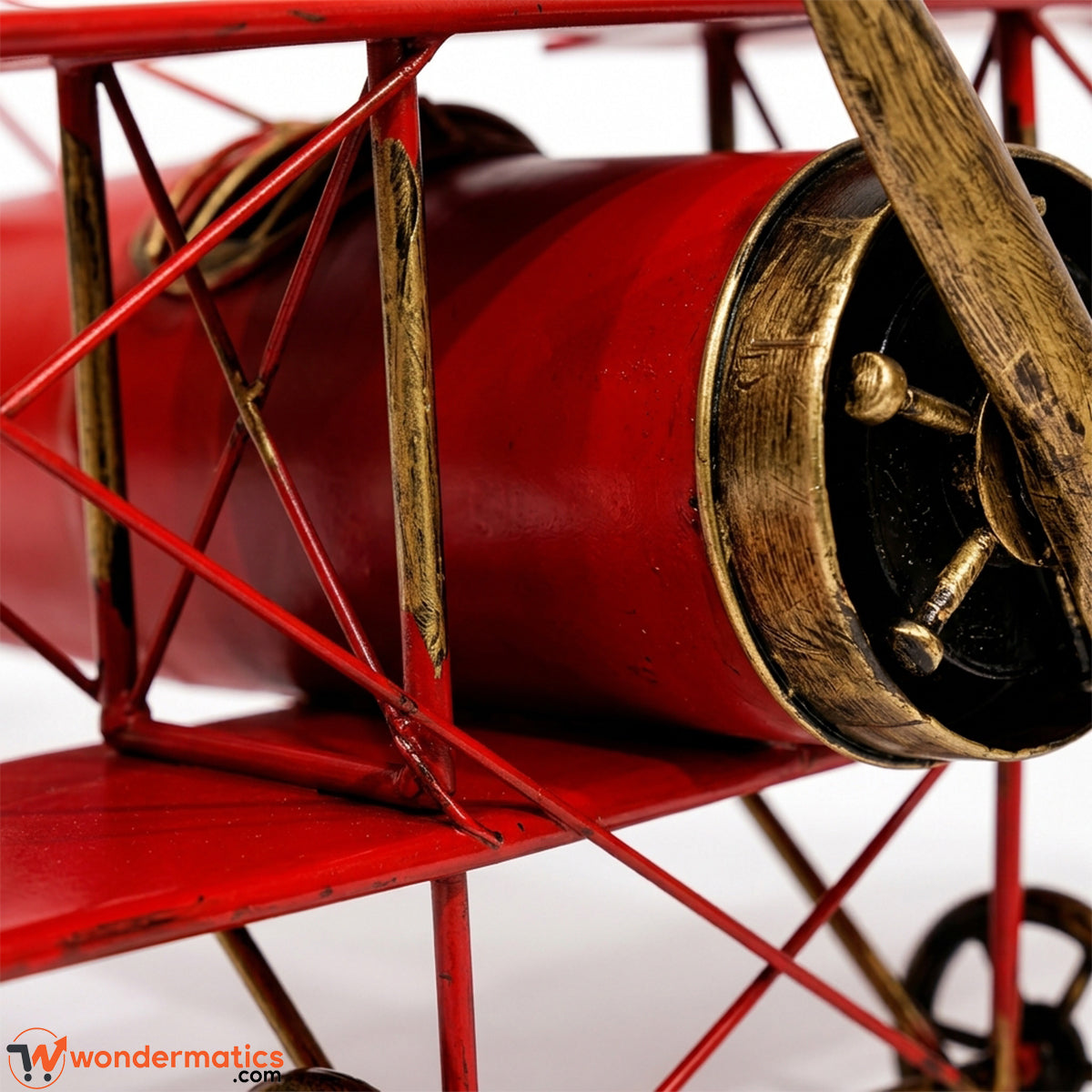 Close-up of red metal finish and biplane body craftsmanship
