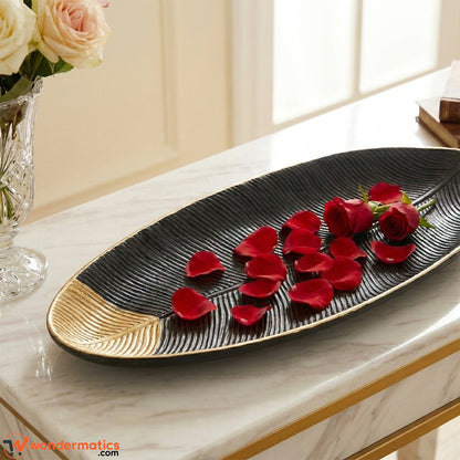 Closeup of leaf shape design and gold detailing on wooden decorative tray