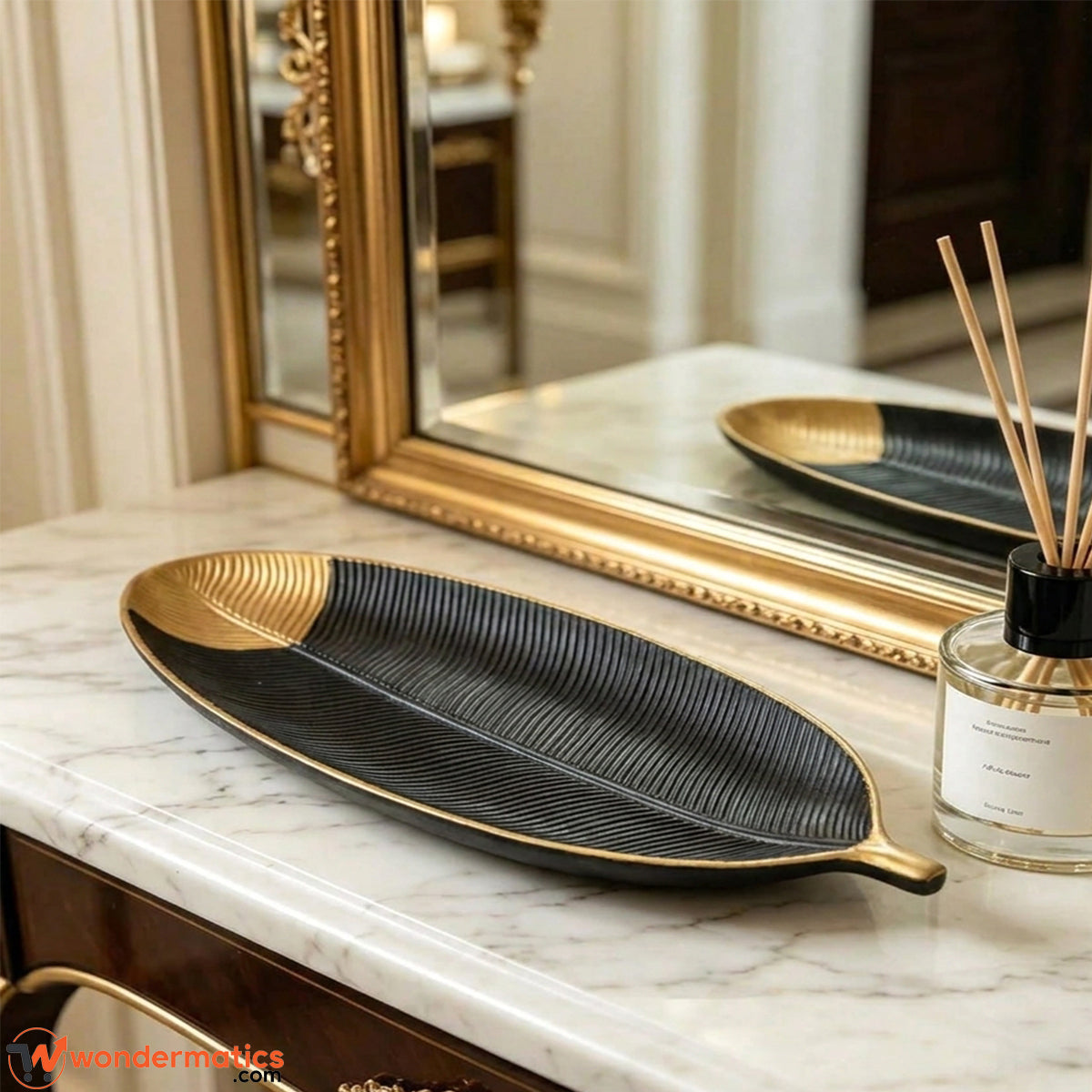 Black and gold wooden leaf tray displayed as decor piece on a console table